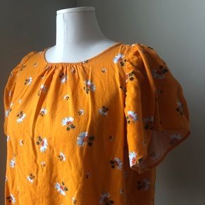 Golden yellow floral top with button back
